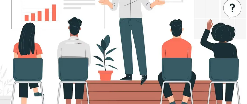 Person on a stage giving a talk while others listen and ask questions